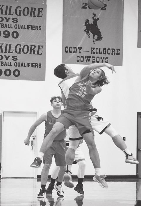 The Badgers and Cowboys go for control of the ball in the game held Tuesday, January 11, in Cody. Photo by Shontell Roseberry