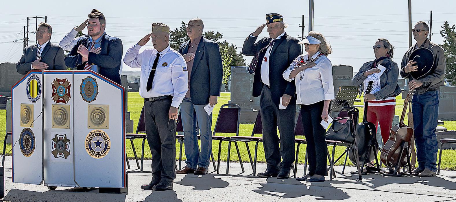 Pictured are from L to R: Pastor Paul Maunu, Tim Witte, Titus Maunu singing the National Anthem, Rex Gallino, Tim Wilkinson, Don Nelsen, Ginny Nelsen, Kitty Vander Wey, and Rick Vander Wey. Photos by Laura Vroman