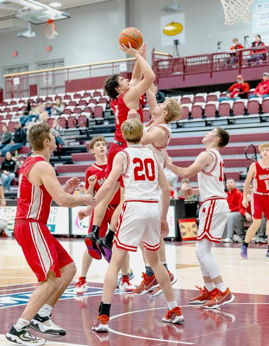 Andon Olson, heavily guarded, takes it to the basket.