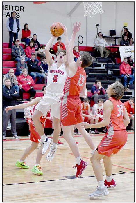 Jack Lancaster #13 attempts a block under Ainsworth’s basket.