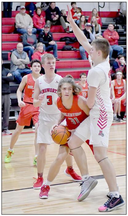 Nathan Perrett #31 gets the ball around his Ainsworth defenders. Photos by Rod Worrell