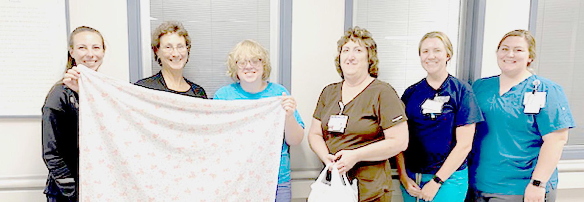 Meadow Reinders, pictured above, third from the left, is a local seventh grader who learned to sew and made receiving blankets for newborns at Cherry County Hospital for her Girl Scout Silver Award. Meadow was born at Cherry County Hospital a few weeks premature and was transferred to Good Samaritan Hospital in Kearney. She has made blankets to give to the Good Samaritan Hospital’s Neonatal Intensive Care Unit also.