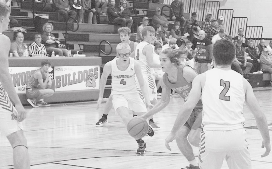 Nathan Perrett is driving the ball in past his defenders in the game against Ainsworth. Photo by Mary Reagle