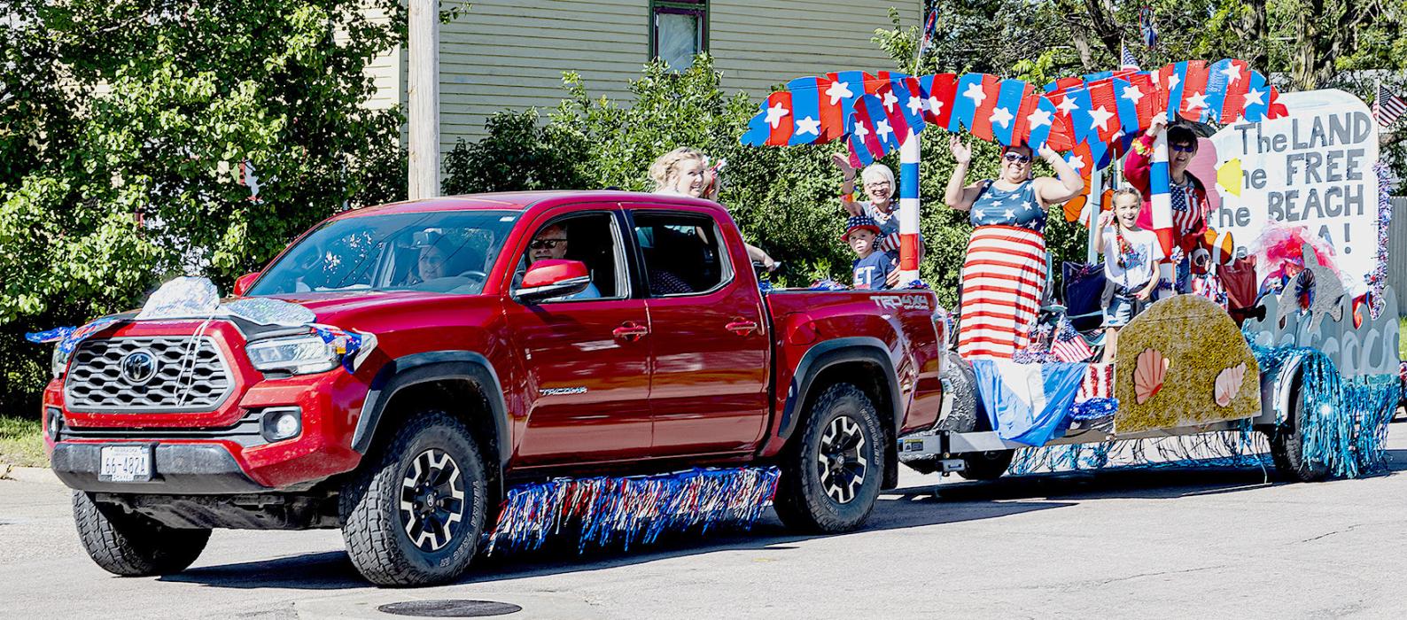 Pictured above is the Roth Family float, and below is the Valentine Swim Team, both winners in the Liberty Fireworks sponsored parade. Photos by Laura Vroman