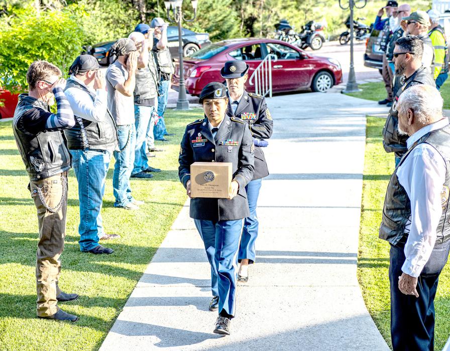 Freedom Riders lined the walkway to Sandoz Chapel of the Pines as First Sergeant Jensen, carrying the U.S. Flag, and Sergeant Hocog carried PFC Dale Thompson’s remains in a brushed gold vault. He was finally home. Photo by Laura Vroman