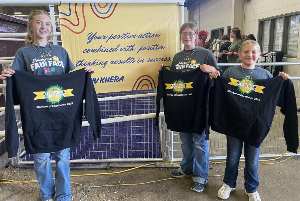 State Fair Premier Livestock Exhibitors - Maysa, Mahaya and Makamry Jones, awarded hoodies and cash awards sponsored by the Nebraska 4-H Foundation.