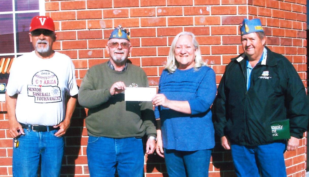 Pictured are baseball Manager/Coach Kent Lopez, SAL Commander Steve Steele, Modem Woodman representative Karla Johnson, and SAL Squadron treasurer Rob Norton accepting the Modern Woodman check.