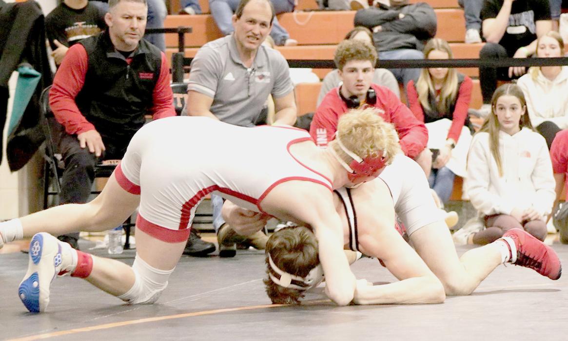 Will Sprenger, 126# earned first place and punched his ticket to state! Coaches Jason Kelber and Shane Allison watch Sprenger’s match in progress.