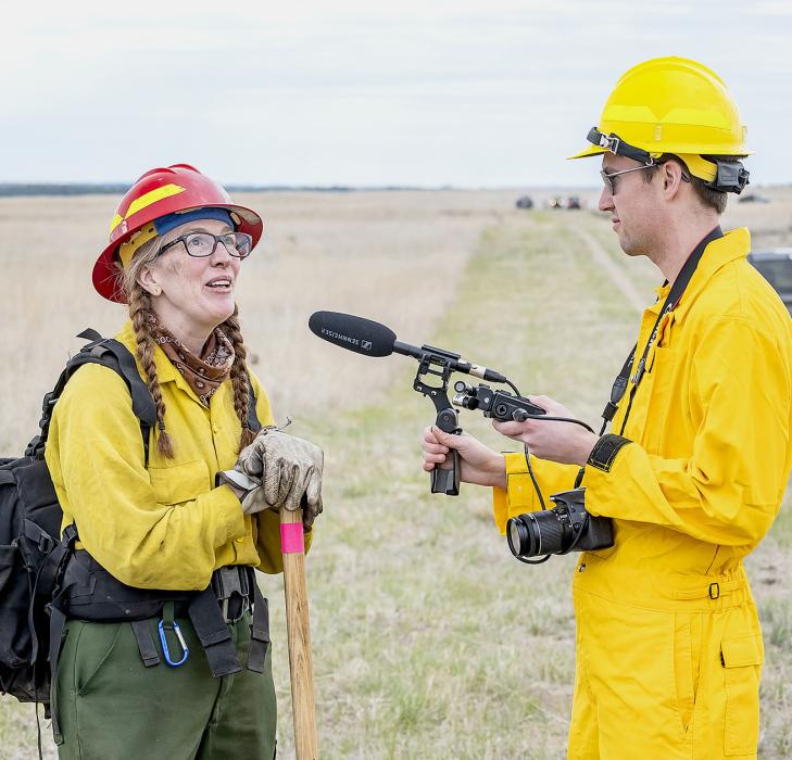 Virginia Avery, a clinical social worker from Missoula, MT, visits with Brian, a young reporter just out of college - working on his first story for NPR through National Public Media. Make no mistake, Virginia is a dynamo, a military veteran, wildland fire fighter, and worked on a hot shot crew. She can speak your language when times get tough. Photos by Laura Vroman
