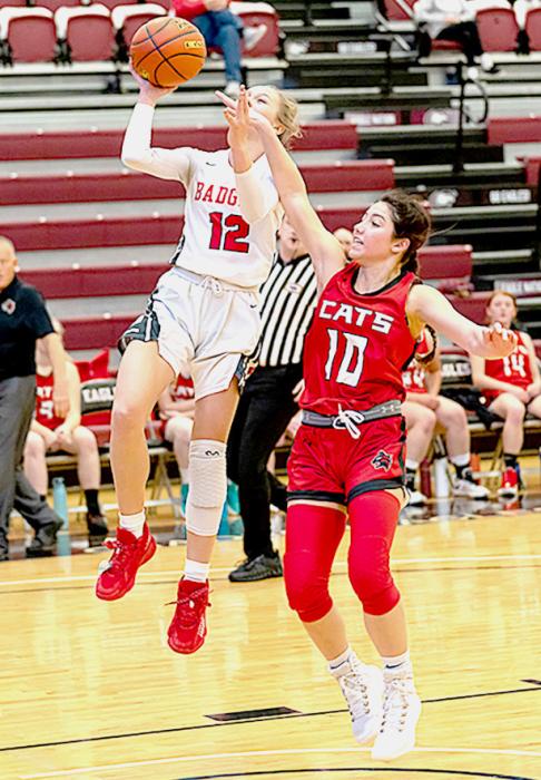 Tacey From #12 is being defended heavily by her opponent in the Holiday Tournament. Photos by Fletcher Larsen