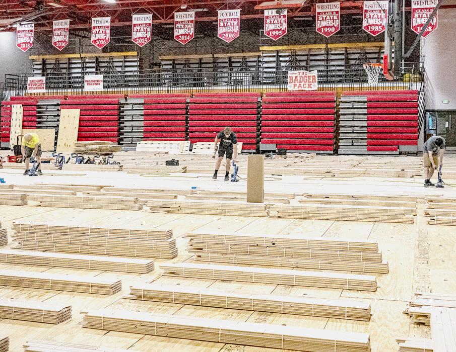 J Floors of Wisconsin was able to fit the VHS gym floor into its schedule. Here they are beginning the laying of the hard wood maple flooring. The flooring was damaged during a torrential rainfall last year, insurance is taking care of the cost of the new floor and its installation. Photo by Laura Vroman