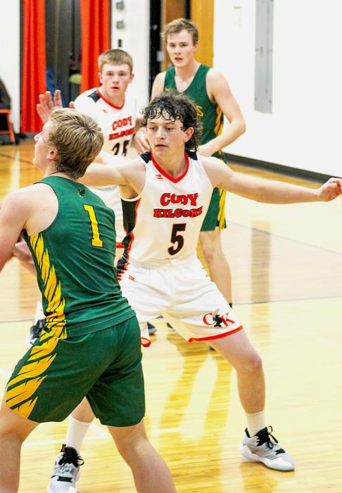 Cowboy Drew Farrell #5 closing out on a Hawk.