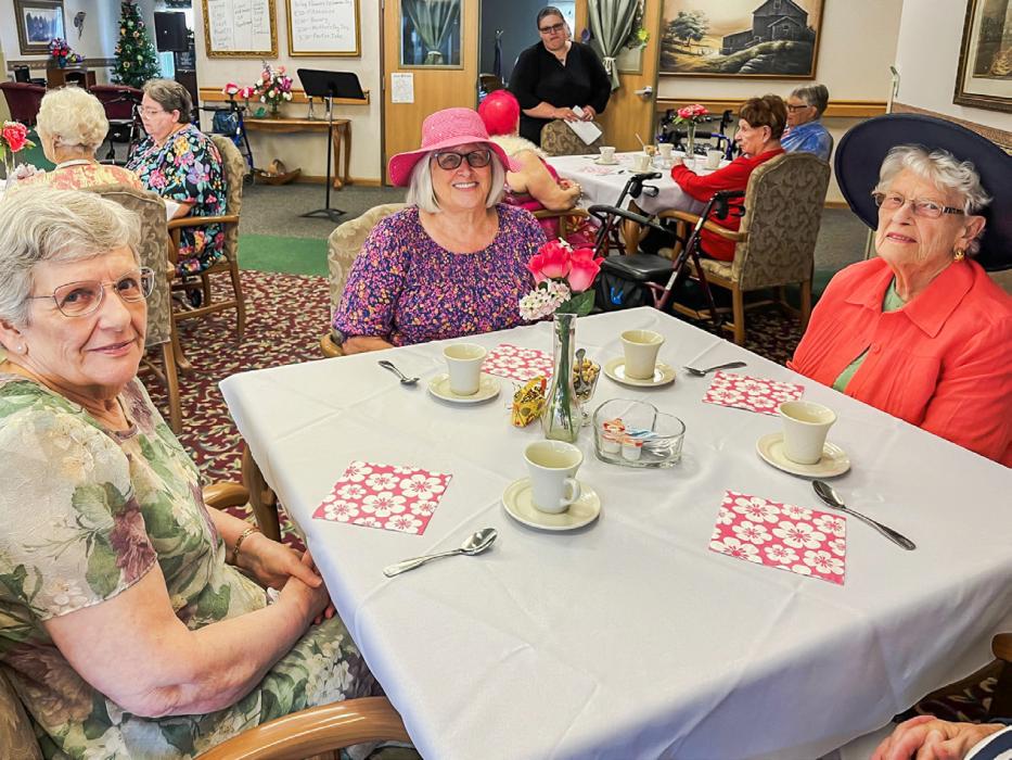 Hot teas were served along with raspberry thumbprint cookies, and centerpieces of pink flowers adorned the tables.