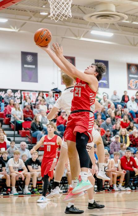 Andon Olson #21 goes for a layup in Saturday’s game against Cozad.