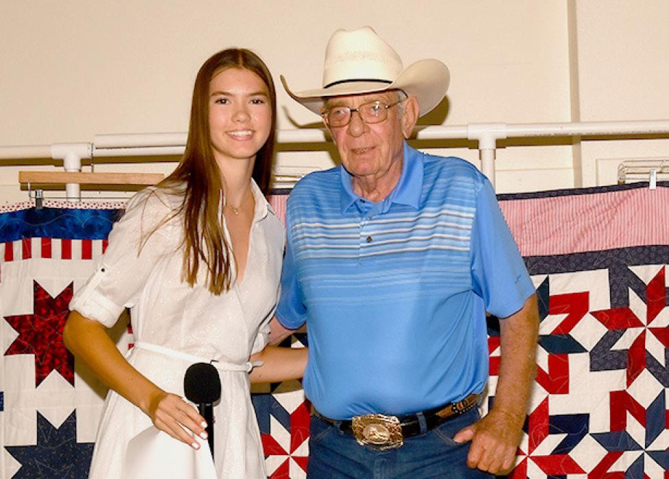 Kate Cox presents Doug Mulligan with his Quilt of Valor.