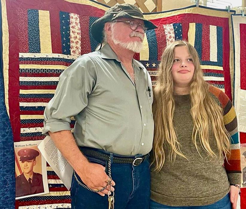 Sophia Schadel presents William LeMaster his Quilt of Valor. Photo by Andrea Schadel