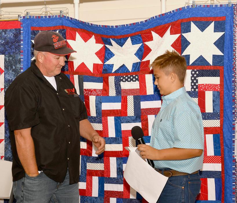 Will Cox presents Rex Gallino with his Quilt of Valor.
