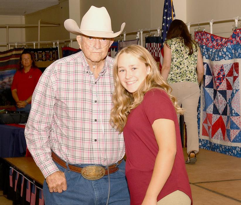 Cadence Swanson presents Kenneth Churchill with his Quilt of Valor.