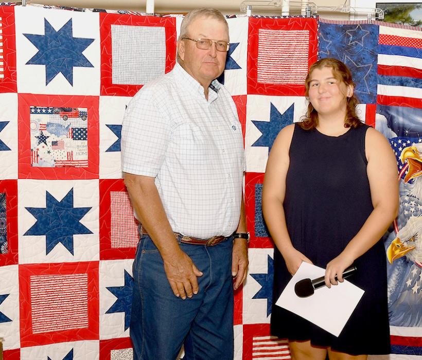 Jenalee Garwood presents Gayle “Duff’ Tinant with his Quilt of Valor.