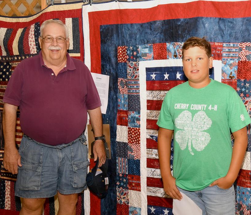 Jaeden Garwood presents Bill Potter with his Quilt of Valor.