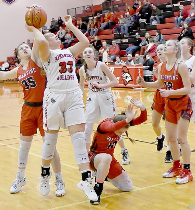 Fayth From ducks after fighting for a rebound with Ainsworth’s Kaitlyn Nelson while Kinsey Buechle gets a hand on the ball to avoid a rebound shot by Nelson. Photos by Rod Worrell