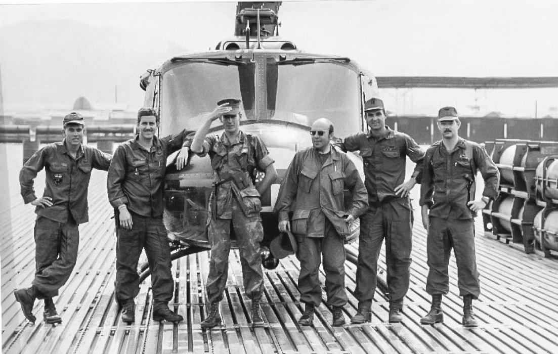 Pictured from L to R: SP5 Tom Franks, flight medic; SP5 Dave Farnum, crew chief; unidentified Marine reporter bodyguard; Gunter Stiller, Chief Reporter for Bild am Sonntag newspaper; Captain Robert Robeson, aircraft commander; and CW2 Tim Yost, now deceased copilot, at Red Beach heliport after flight to evacuate captured and seriously wounded NVA officer. Photo by Gunter Stiller