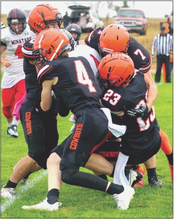 A posse of Cowboys in on a tackle against the Indians. Photo by Shontell Roseberry