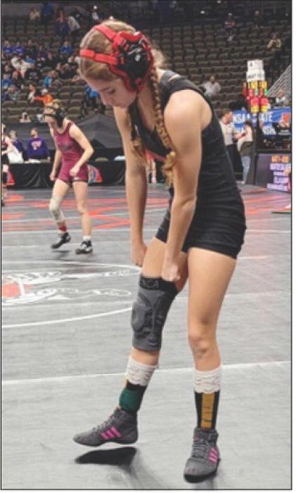 Reegan Eggert adjust her gear for her next match in the 100#.