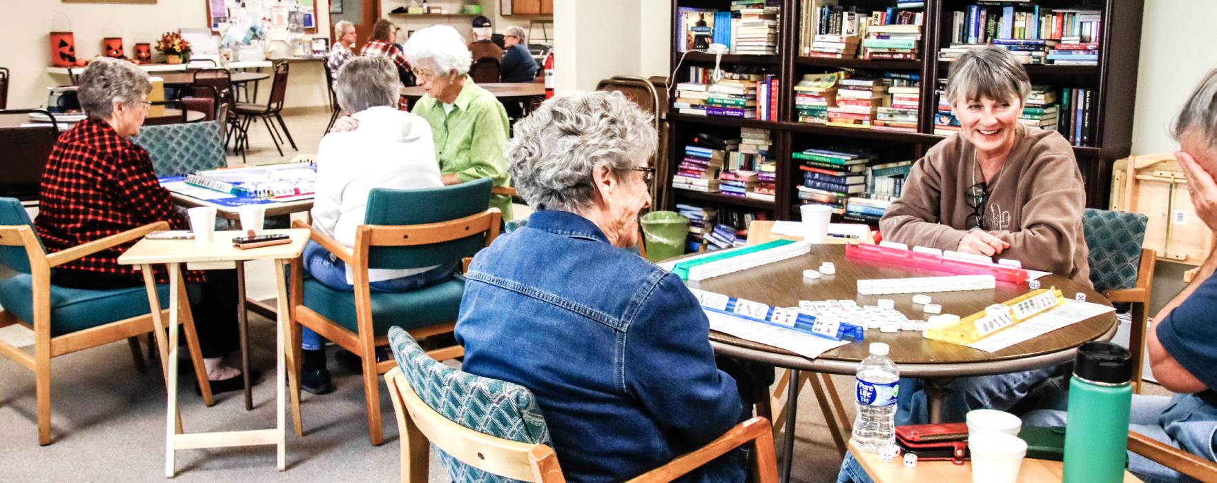 Playing a friendly game of Mahjong, these women are enjoying the Valentine Senior Center as a gathering place - because it’s so much more than an excellent lunch. Photo by Tina Boone