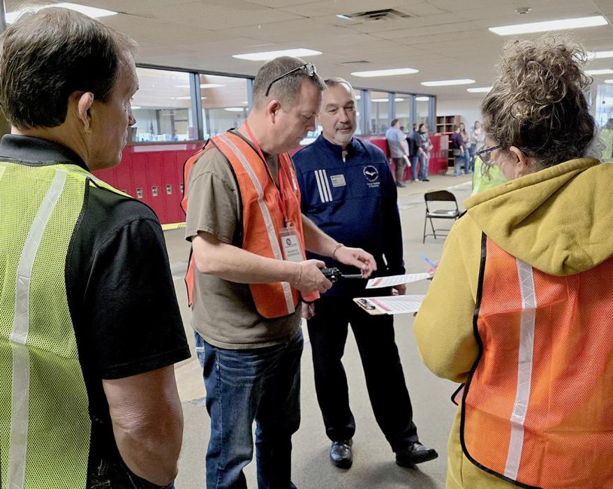 Organizer Scott Stemper of Nebraska Department of Education’s School Safety Program looks on while VMS Principal Mr. Sayer insures good communication with other reunification protocol members. Mr. Allison far left, will help with the flow of “students” who will be reunified with their parents in this live training. Photos by Laura Vroman
