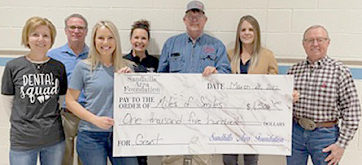 Pictured are from L to R: Diane Alden, Miles of Smiles; Steve Brown, Sara Twibell, Miles of Smiles; Kimberly Johnson, Gregg Perrett, Talia Benson and Monty Neiffer.