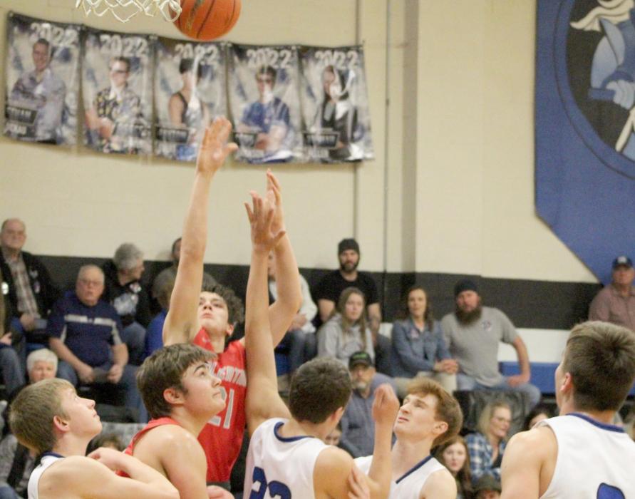 Andon Olson going up for a heavily guarded shot in the game against North Central. Photos by Mary Reagle