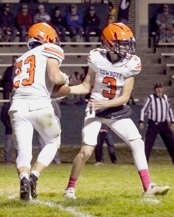 Tristan Fish #3 hands the ball to Jacob Knox #23.