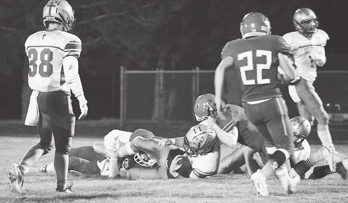 Conner Fowler and Ashton Lurz bring down St. Pat’s ball carrier in the game Friday, October 22, 2021.
