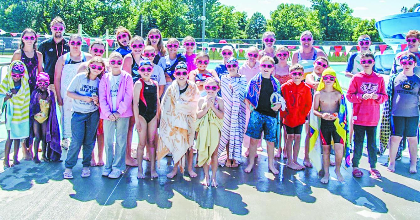 Swimmers gather together after competition for medals, smiles, and coolest tropical pink shades!