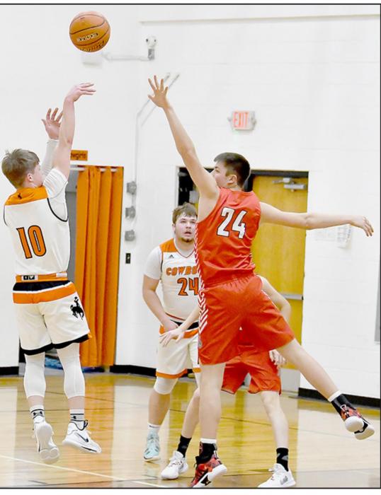 Cooper Fay shoots over the 6’ 4” Trey Appelt of Ainsworth. Photos by Rod Worrell