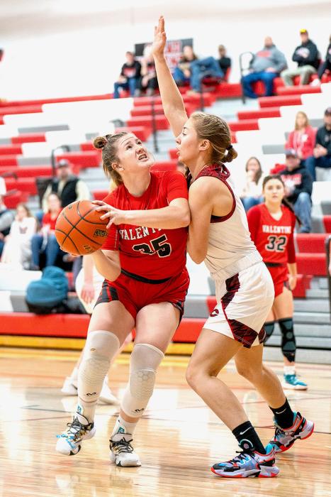 Kinsey Buechle #35 moves her guard and attempts a basket in Saturday’s match up against Cozad.