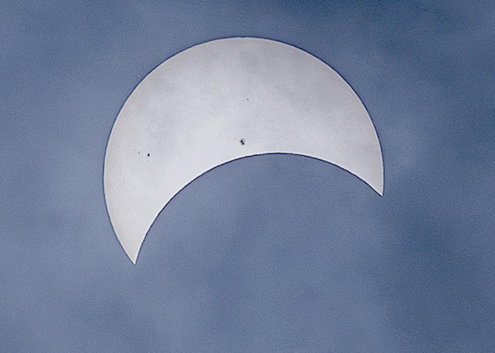 Cloudy skies made photographing the eclipse challenging, but viewing among the swirling clouds was riveting! Notice the sun spots visible - reserved for cloudy, or smoky skies, but always there. Photo by Laura Vroman