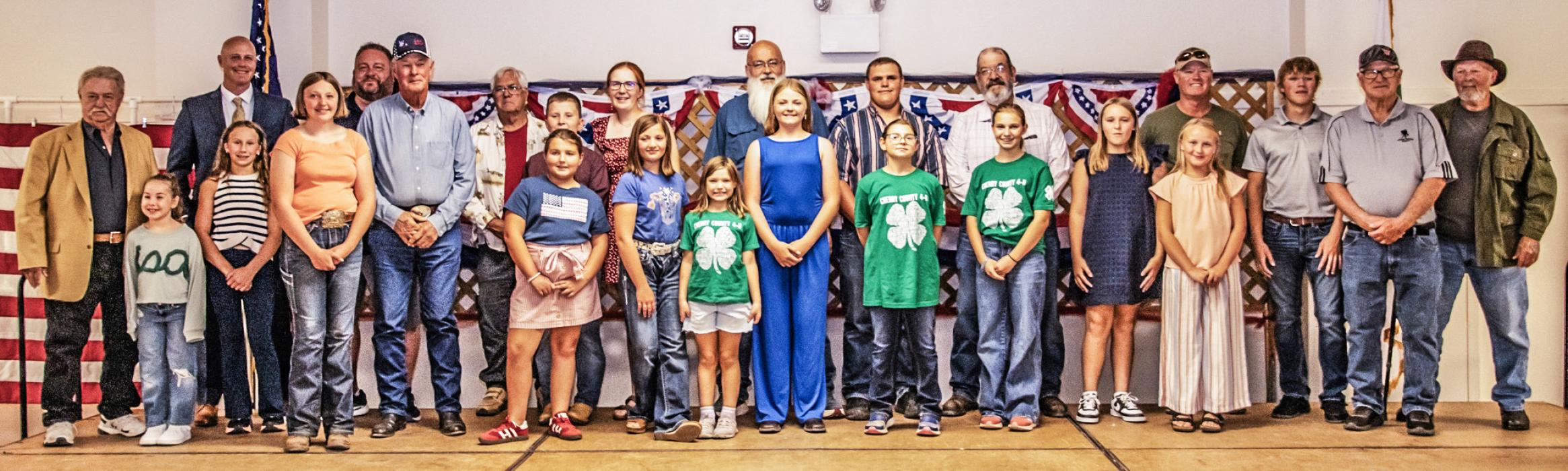 4-Hers and veterans gather together after the Quilts of Valor were presented.