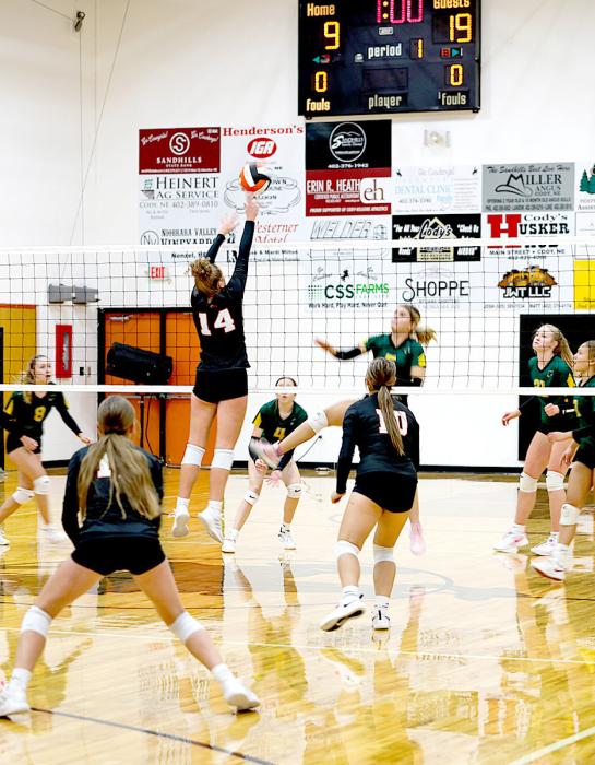 Kayleigh Ravenscroft #14 gets a hand on the ball at the net.