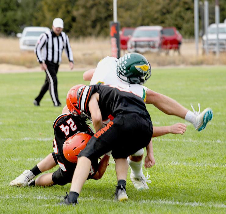 Hesston Fay #24 tackles a Hawk with assistance from Jasper Roseberry #21.