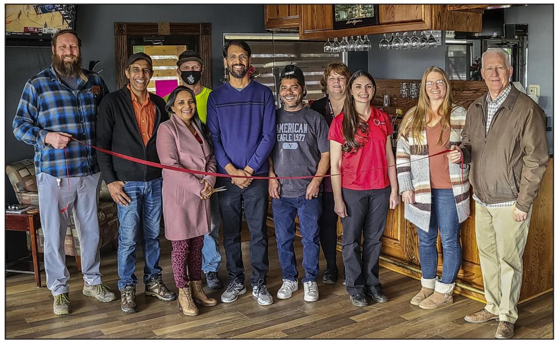 Pictured at the Raine Motel Ribbon Cutting are from L to R: Chris Hernstrom, Mr. Robby Chawla, Chanchal Shukla Owner, Jason Wingrove, Andy Sharma, EJ Jaydav, Carolyn Petersen, Ann Krueger, Deanne Holmes Monroe, and Dean Jacobs. Photo by Laura Vroman