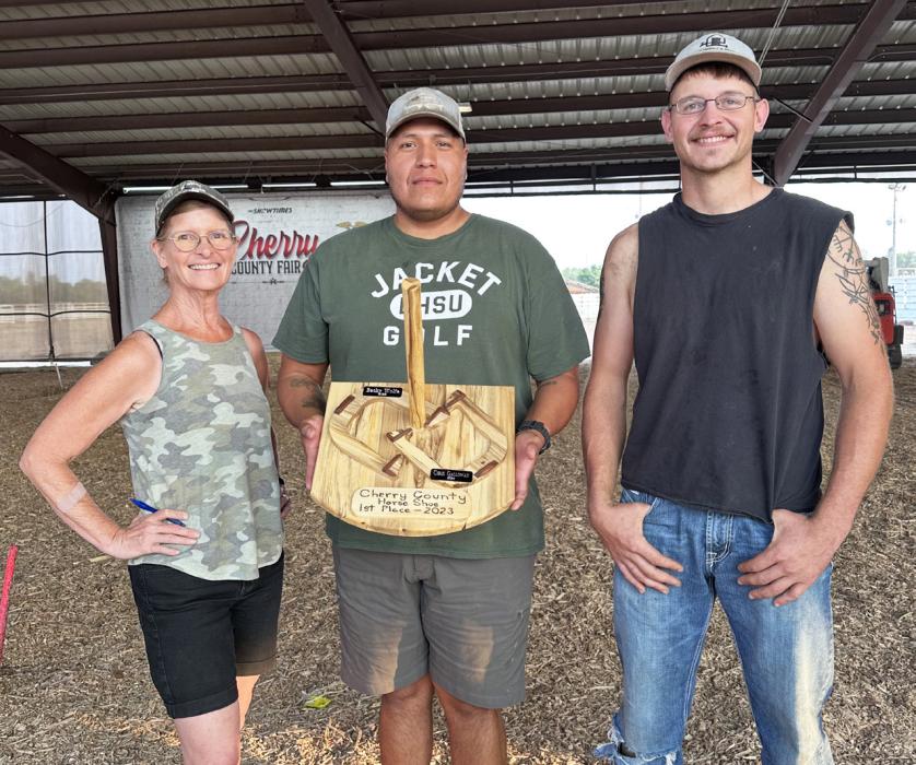 First place, Earl Peneaux Jr., center; second place, Becky Wolfe, left; third place, Augie Galloway, right.