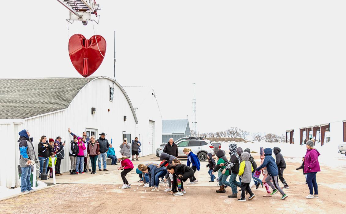 Amid the mud, ice, and crazy wind gusts, the annual Chamber of Commerce Raising of the Heart and ping-pong ball drop was a success with kids gathering up unknown prizes!