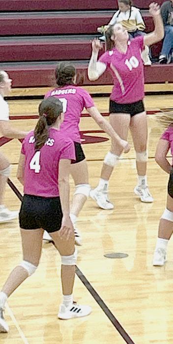 Senior Kinsey Buechle goes in for an attack against Ogallala as teammates cover.