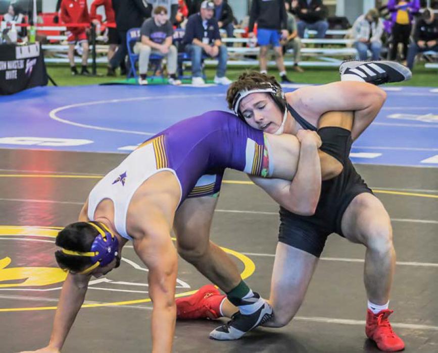 Senior Cooper Phillips drives his opponent to the mat during the first day of competition at the Norm Manstedt Tournament. Cooper finished the tournament with a seventh place finish.