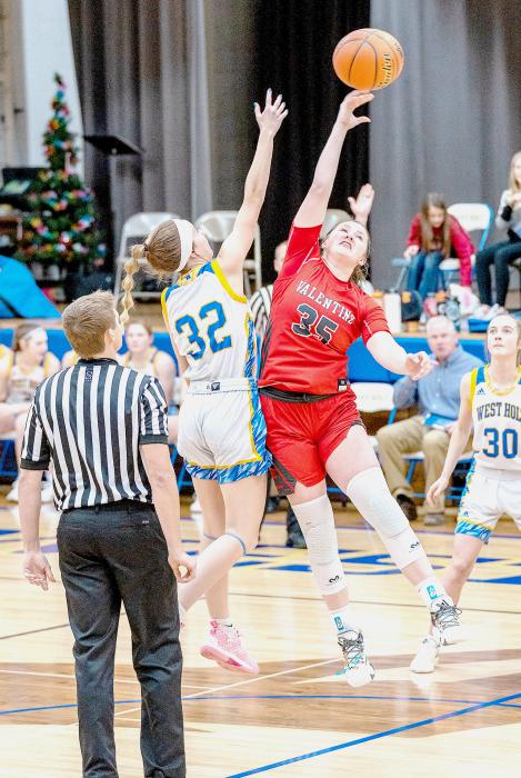 Kinsey Buechle grapples for control of the ball at the tip-off. Photos by Fletcher Larsen