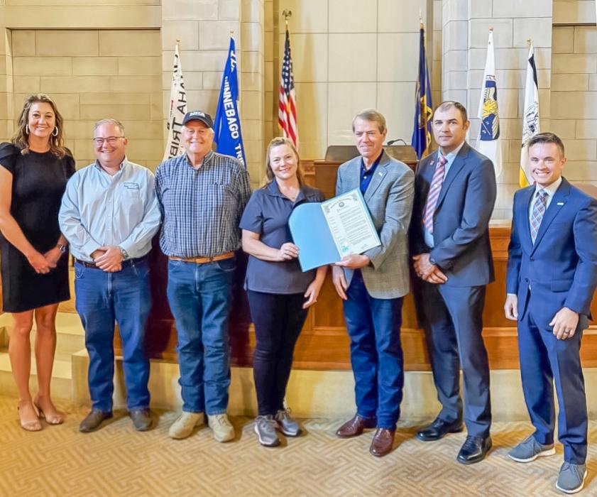 Wendy Murphy, center with Governor Pillen after signing a proclamation designating August as National Shooting Sports Month in Nebraska.