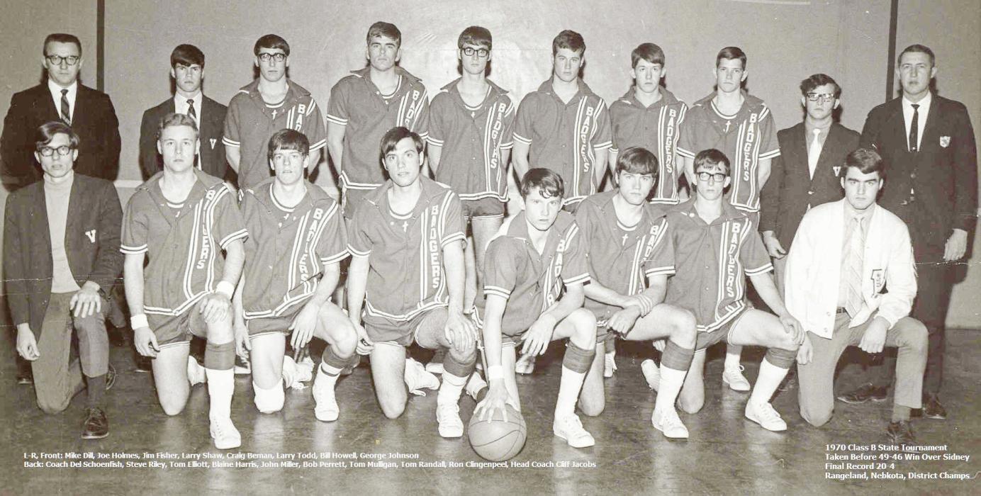 Pictured are the 1970 Class B State Tournament Badger Basketball Team. Back row, L to R: Coach Del Schoenfish, Steve Riley, Tom Elliott, Blaine Harris, John Miller, Bob Perrett, Tom Mulligan, Tom Randall, Ron Clingenpeel, Head Coach Cliff Jacobs. Front row, L to R: Mike Dill, Joe Holmes, Jim Fischer, Larry Shaw, Craig Beman, Larry Todd, Bill Howell, and George Johnson. The photo was taken before 49-46 win over Sydney with a final record 20-4. Rangeland, Nebkota, District Champs.