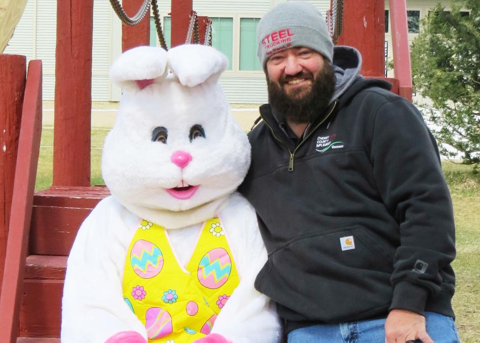 Pictured at the top, this young one and the fluffy bunny clearly had much to visit about; the giant fuzz ball then made time to visit with Monty Krueger, above, who helped with the candy donations. Photos by Tina Bone